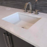 A luxurious white marble with delicate gold and grey veining.