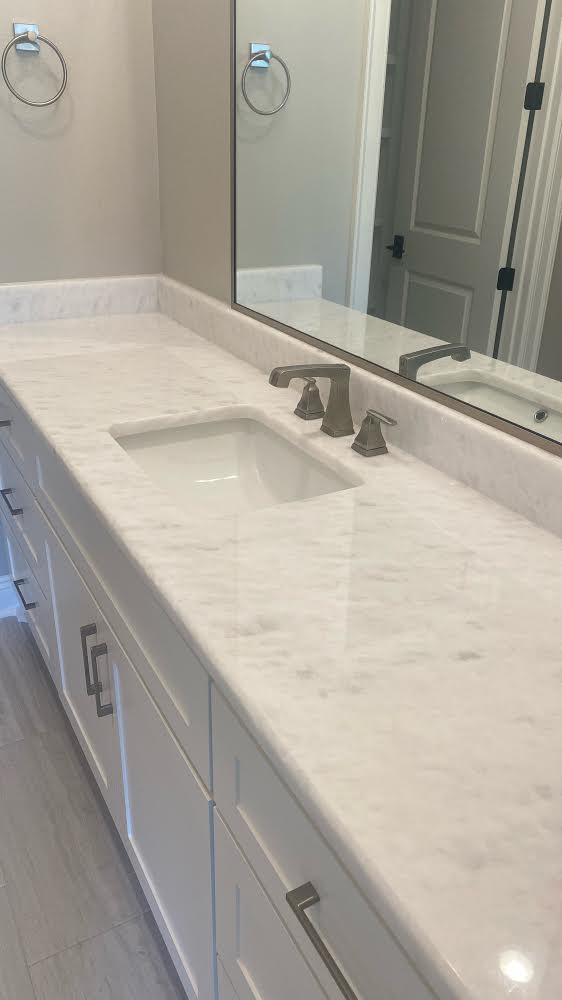 A natural white marble with fine light grey veining. 