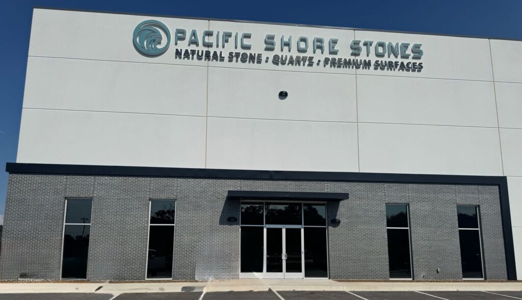 Front view of the Pacific Shore Stones building with logo and slogan 'Natural Stone · Quartz · Premium Surfaces