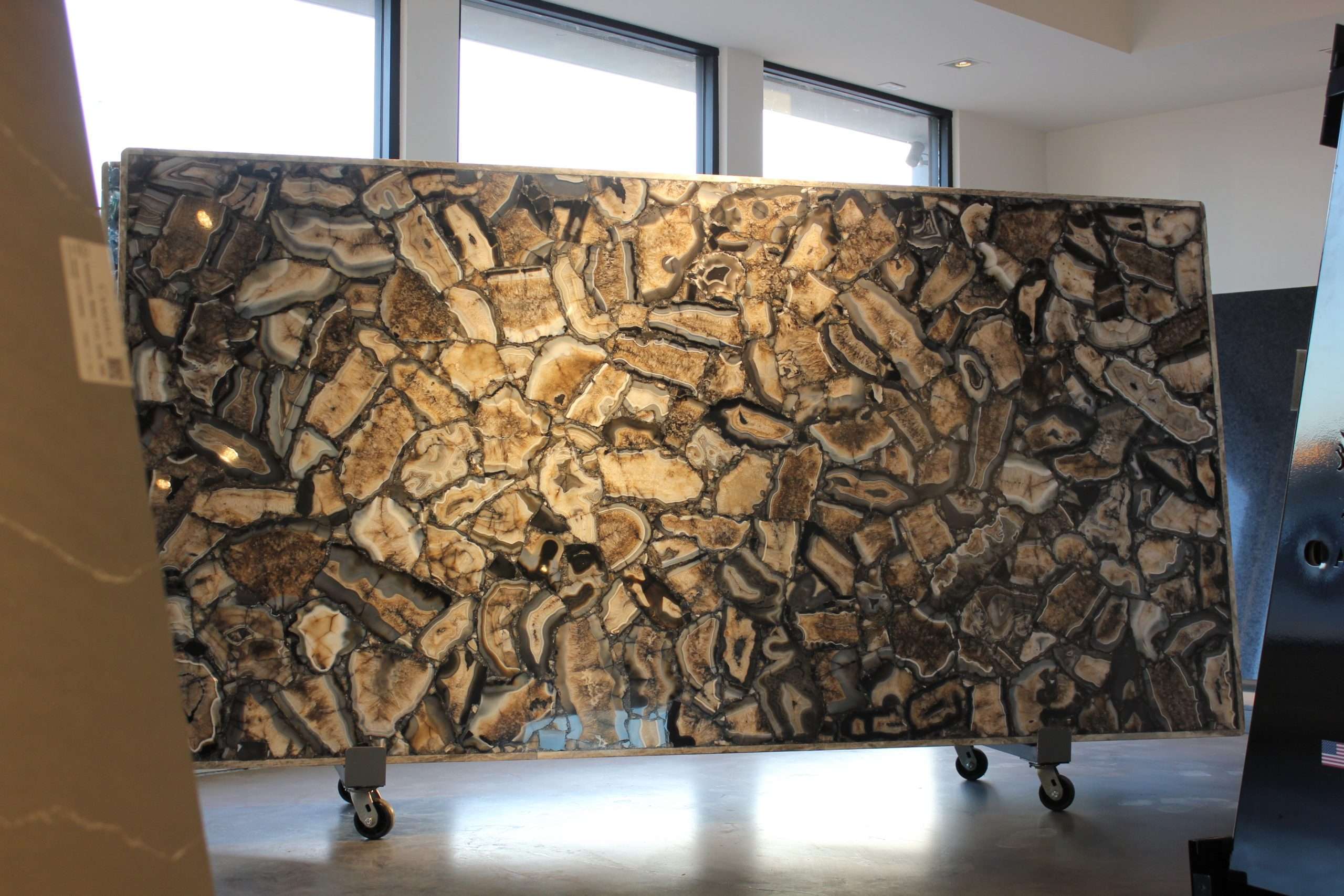 Large slab of Wild Black Agate semi-precious stone featuring translucent neutral and dark crystalline patterns for luxury interior design.