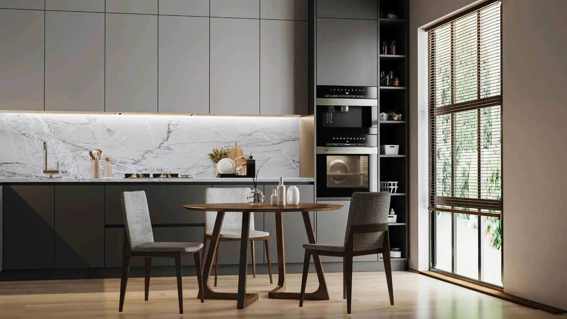 Minimalist gray kitchen with white marble backsplash, built-in appliances and round wood dining table