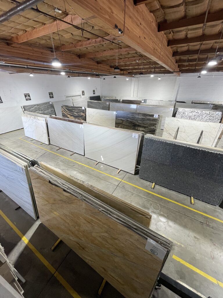 Stone fabrication workspace with equipment and materials in Fresno facility