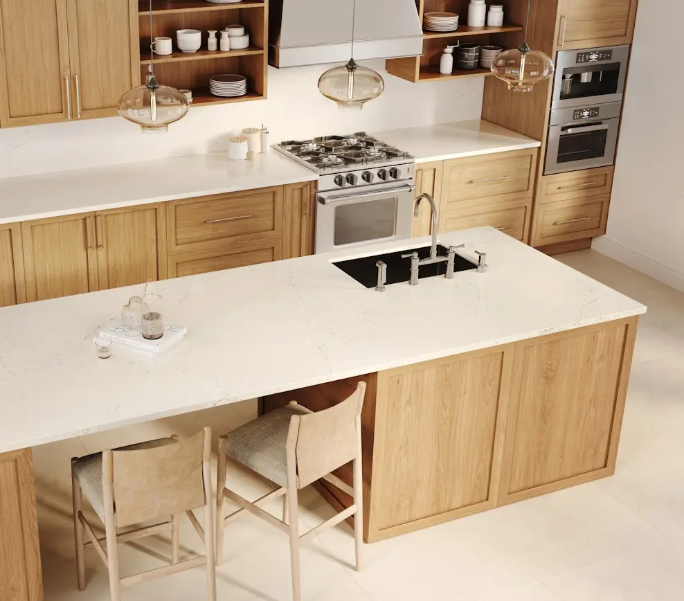 Warm oak kitchen with white quartz countertops, center island and amber glass pendant lights