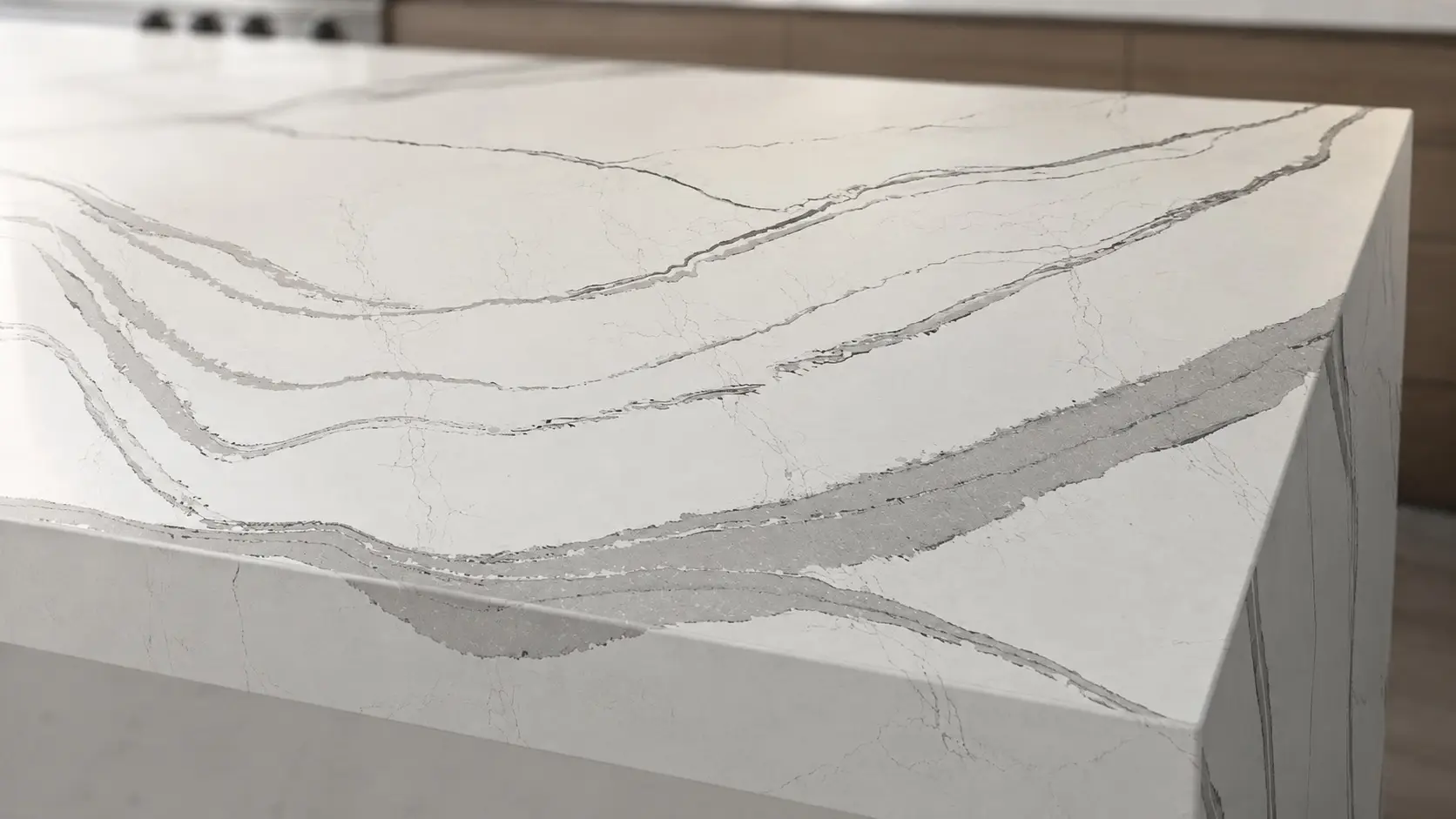 Close-up of a Cambria Brittanicca kitchen island with bold gray veining across a white quartz surface.