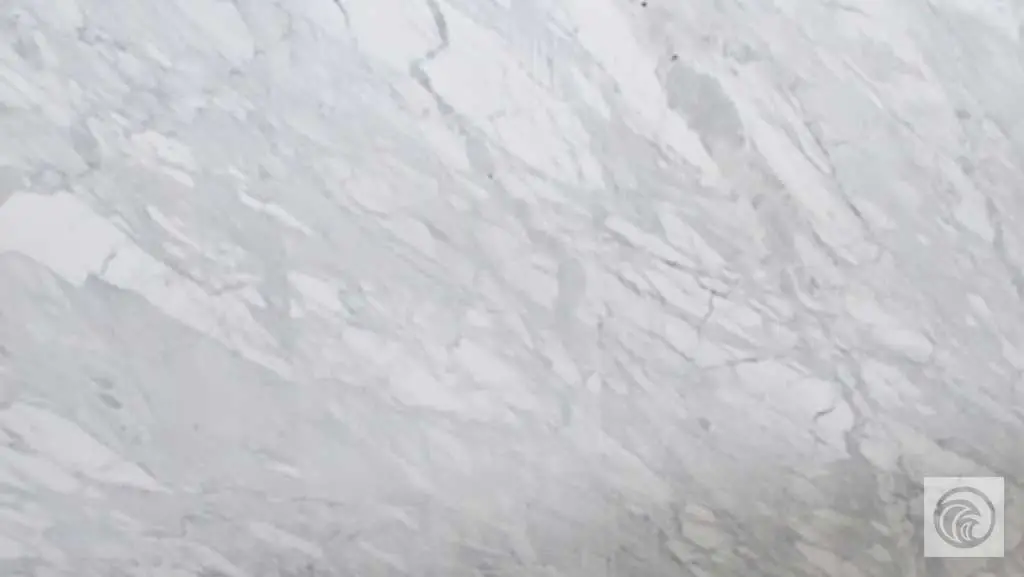 Calacatta marble slab with a white background and sweeping gray veining