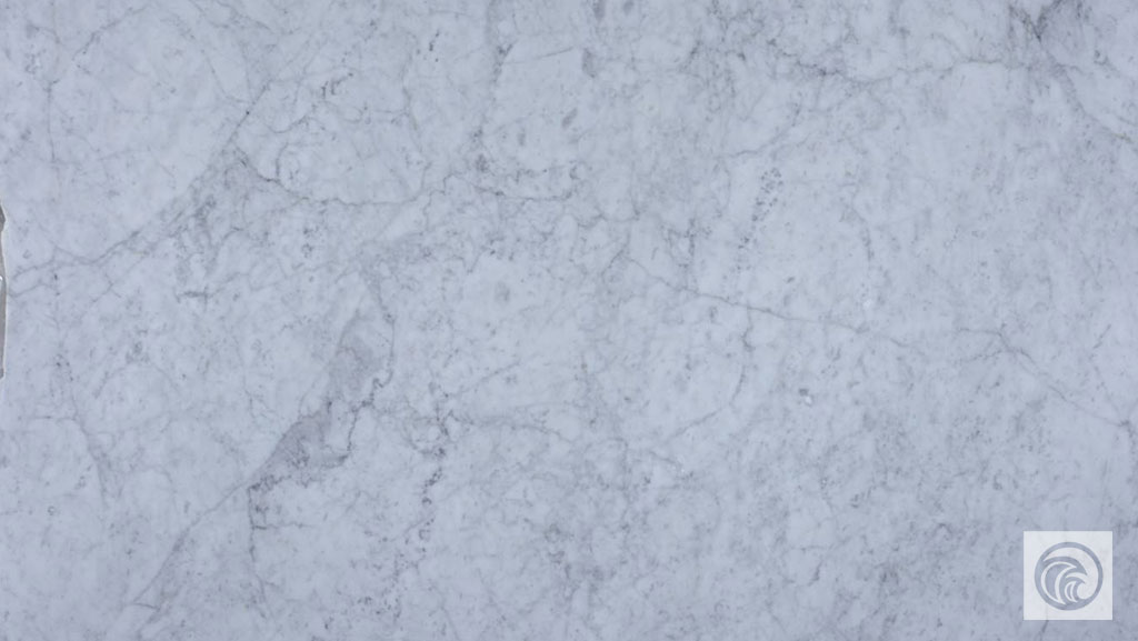 Bianco Carrara marble slab with a light gray background and fine, cloudy gray veining