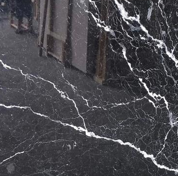 Nero Marquina marble slab with a black background and striking white veining