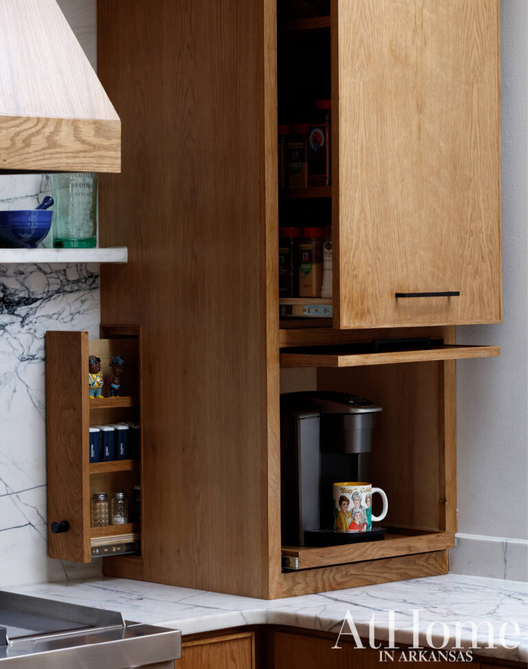 Custom oak cabinet beside the range with a pull-out spice rack and a pull-out shelf that hides the coffee maker.
