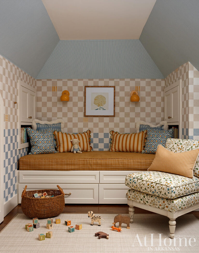 Cozy children's room with a built-in daybed, checkered walls, colorful pillows and traditional furnishings