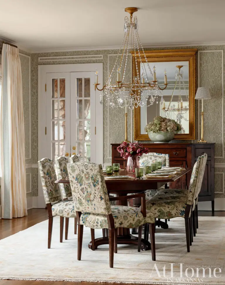 Elegant traditional dining room with floral upholstered chairs, crystal chandelier and antique wood furniture